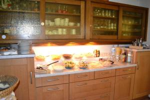 a kitchen counter with bowls of food on it at Gaestehaus Tagescafe Eckenfels in Ohlsbach