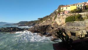 a view of the ocean with houses on a cliff at Il Melograno B&B in Albiano