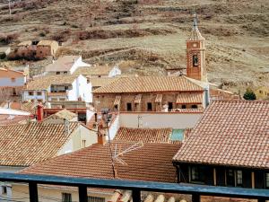 a view of a town with a clock tower at Cielo de Camarena in Camarena de la Sierra