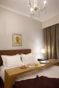 a bedroom with a bed with a tray of food on it at Apartment at Koukaki, 150m from the metro by YHA in Athens