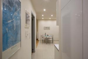 a hallway leading to a dining room with a table at Apartment at Koukaki, 150m from the metro by YHA in Athens