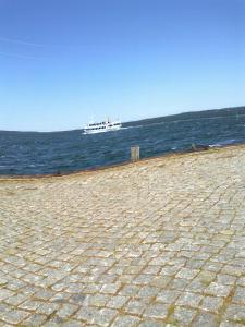 a cruise ship in the ocean with a beach at Apartments zum Brauergang in Garz