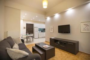 a living room with a couch and a flat screen tv at Apartment at Koukaki, 150m from the metro by YHA in Athens