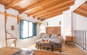 a bedroom with a bed and a table in a room at Casa Rural Sierra de Huelva in Aroche