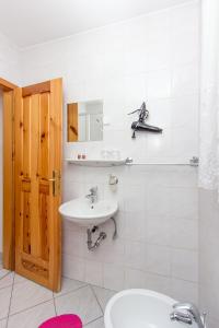 a bathroom with a sink and a toilet and a mirror at Guesthouse Kaučič in Benedikt v Slovenskih Goricah