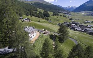 a large house on a hill in a valley at Chalet Charm in Livigno