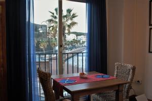 a dining room table with a view of the ocean at Blue Moon Hotel in Pantelleria
