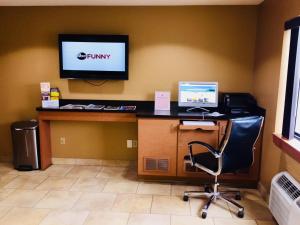 an office with a desk with a computer and a tv at Super 8 by Wyndham Radcliff Ft. Knox Area in Radcliff