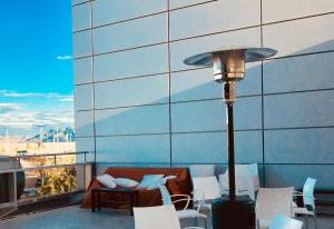 a lamp on a balcony with a table and chairs at Torrecobijo in Sangonera La Seca