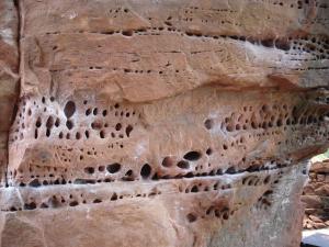 an image of a rock wall with holes in it at Camping-Bungalows Ciudad de Albarracín in Albarracín