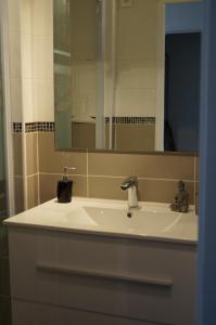bagno con lavandino e specchio di Les Roches Rouges a Cap d'Agde