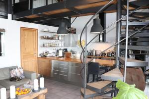 a kitchen with a spiral staircase in a room at Skylark Bed & Breakfast in Grasse