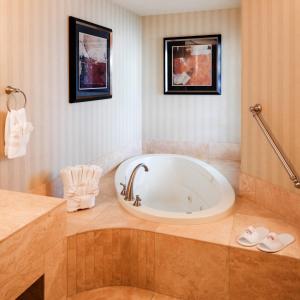 a bath tub in a bathroom with two pictures on the wall at Eureka Casino Resort in Mesquite