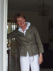 a woman is standing in a room at B&B De Rozenhorst in Baarlo