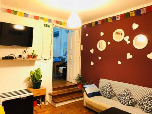 a living room with a couch and plates on the wall at Asian Everest House in Lisbon