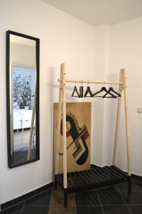 a mirror and a swing in front of a room at Ferienwohnung Alexander in Weimar