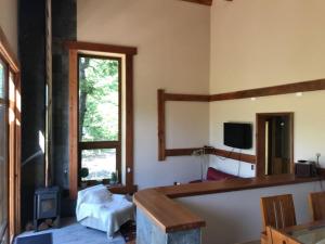 a room with a bedroom with a bed and a mirror at Cabañas JL in Las Trancas