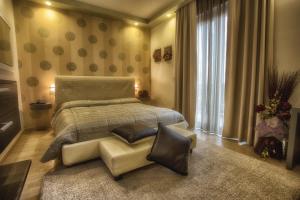 a bedroom with a large bed and a chair at La Grotta Hotel in Verona