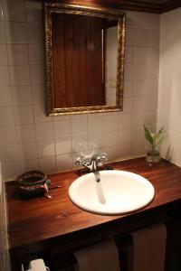 a bathroom with a sink and a mirror on a counter at Mañuko Benta in Bermeo +50 photos