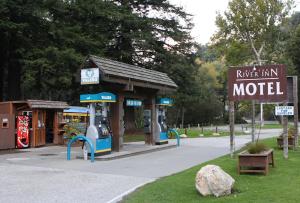 a model gas station in a park with a sign at Big Sur River Inn in Big Sur