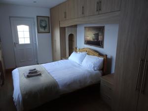 a bedroom with a white bed and a window at St Georges sea view in Sunderland