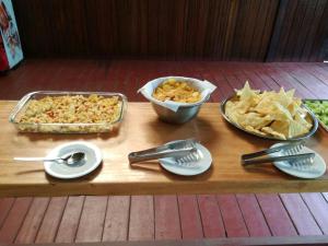 a wooden table with a tray of food and chips at Paradise Amazon Tambopata Ecolodge in Puerto Maldonado +48 photos