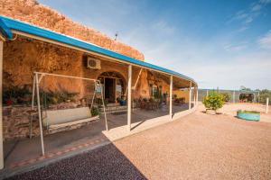 an outside view of a building with a patio at The Underground Motel in Coober Pedy