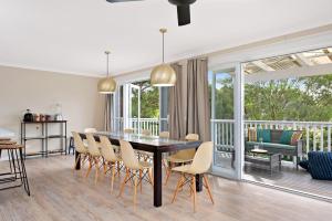 a dining room with a table and chairs at Southern Belle Mollymook in Mollymook