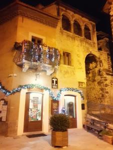 a building with a bunch of bottles on top of it at La Casa dei Nonni B&B in Scanno