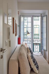 a large couch in a room with windows at Apartment Guarda-Mor in Lisbon