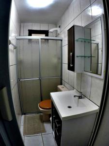 y baño con ducha, lavabo y aseo. en Studio 80m da Praia, en Bombinhas