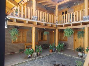 a large wooden porch with potted plants and a patio at Hoteles Viva Tapalpa in Tapalpa