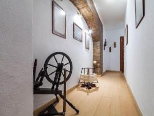 a hallway with a museum with a spinning wheel at Carmen de la Lana in Granada