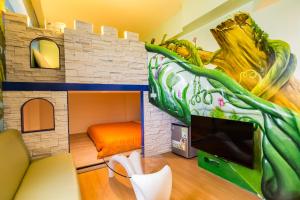 a play room with a bunk bed and a tv at Good Luck Homestay in Xiaoliuqiu