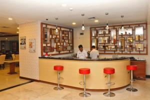 a man standing at a bar in a restaurant at Horison Arcadia Mangga Dua in Jakarta