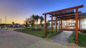 a building with a pavilion next to a parking lot at Ingenia Holidays Rivershore in Maroochydore