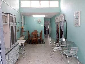 a room with chairs and a table and a dining room at Homestay Ustaz in Taiping