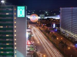 a view of a city at night with a building at Hotel 101 - Manila in Manila