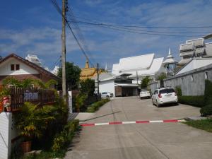 a street with a car parked in a parking lot at Latisha House in Chiang Rai