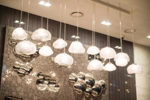 a bunch of lights hanging from a ceiling at ENA Suite Hotel Namdaemun in Seoul