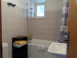 a bathroom with a tub and a sink and a shower at Hôtel Bellier in La Chapelle-en-Vercors