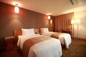 מיטה או מיטות בחדר ב-Byeyer Hotel