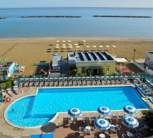 an overhead view of a swimming pool and the beach at Strand Lungomare Apartment in Cesenatico