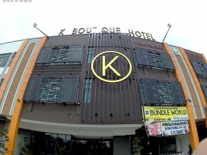 a building with a k sign on the front of it at K Boutique Hotel in Teluk Intan