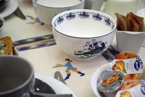 a table with bowls and plates on a table at B&B Vivere Palermo in Palermo