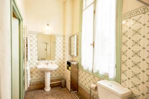 a bathroom with a sink and a toilet and a window at Résidence La Villa Léonie in Nice