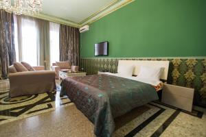 a bedroom with a bed and a green wall at hotel amber in Batumi