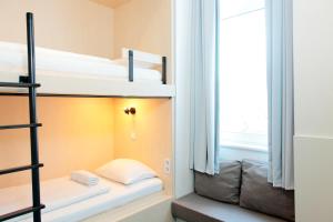 a room with two bunk beds and a window at Maverick Budapest Soho in Budapest