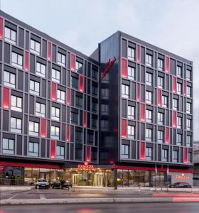 a large black building with red windows on a street at Ramada by Wyndham Istanbul Alibeykoy in Istanbul