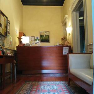 a living room with a wooden floor and wooden furniture at Hotel Agathae in Catania